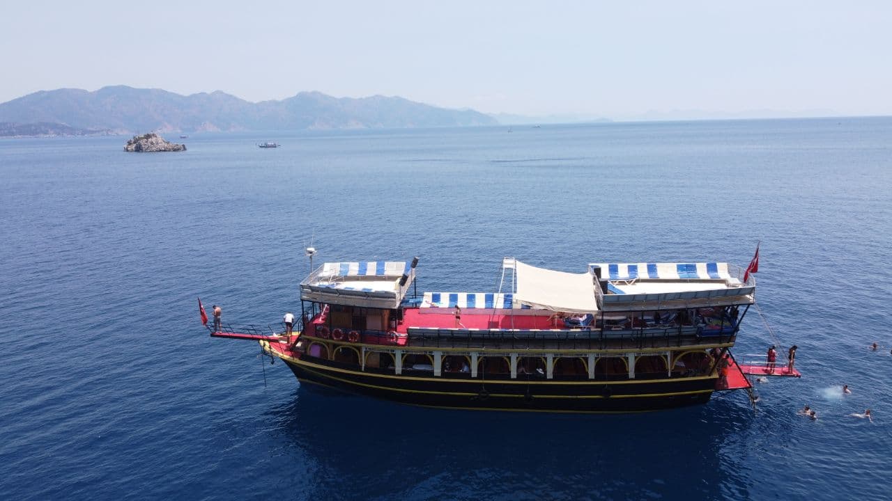 Marmaris boat tour panorama — gulet cruising the Aegean Sea with mountains in the distance